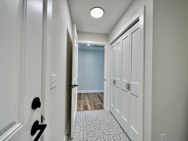 hall featuring baseboards