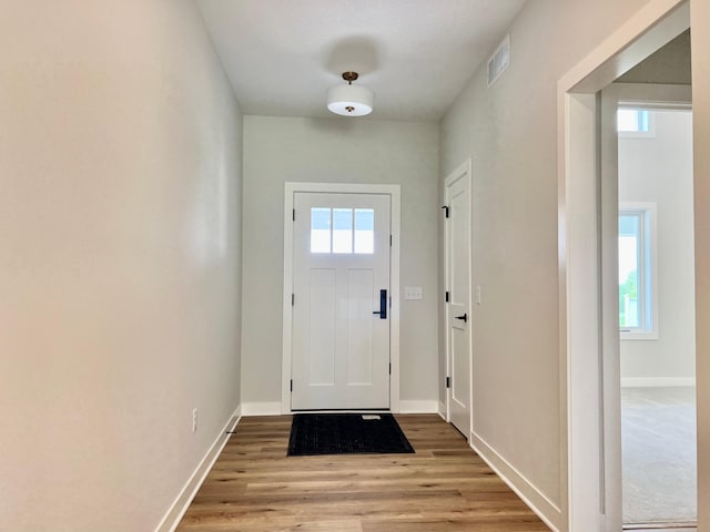 entryway featuring baseboards, light wood-style flooring, visible vents, and plenty of natural light