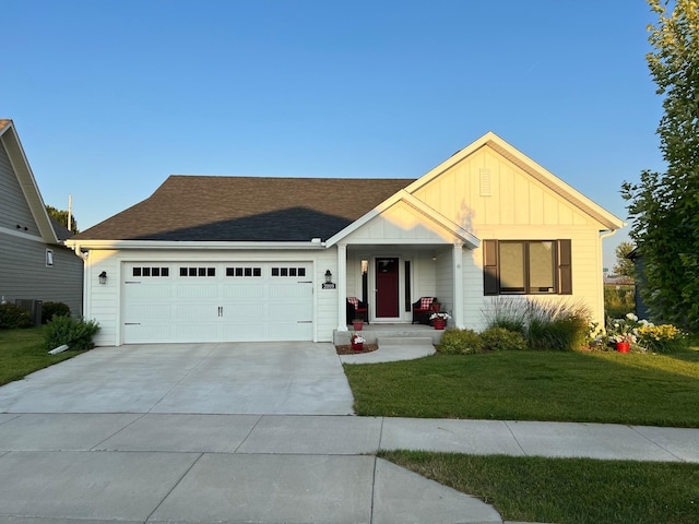 single story home featuring roof with shingles, board and batten siding, driveway, a front yard, and a garage