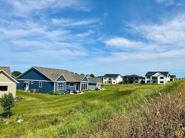 back of property with a yard and a residential view