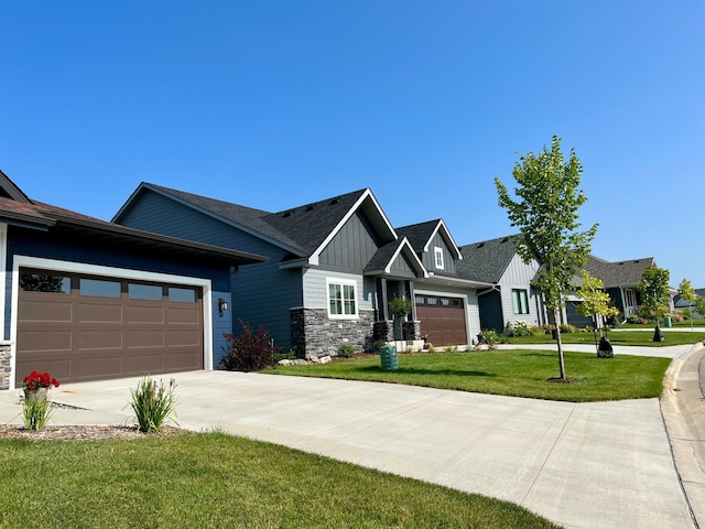 view of front facade with stone siding, concrete driveway, board and batten siding, a front lawn, and a garage