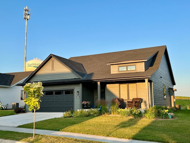 view of front of home featuring a front yard, a porch, a garage, and concrete driveway