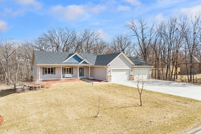 ranch-style house with stone siding, an attached garage, concrete driveway, and a front lawn