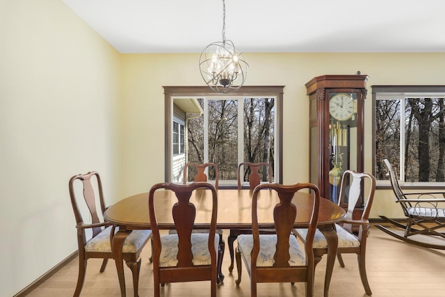 19611 Flamingo St NW, Oak Grove, MN 55011 - dining area featuring light wood-style flooring, a chandelier, and baseboards