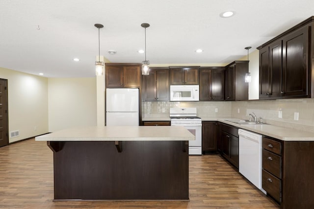 19611 Flamingo St NW, Oak Grove, MN 55011 - kitchen featuring white appliances, dark brown cabinets, a kitchen island, a sink, and wood finished floors