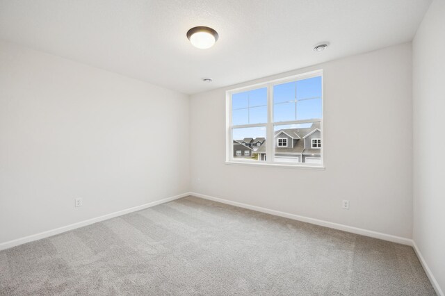 unfurnished room featuring baseboards and carpet floors