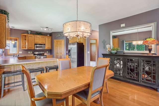 6875 148th Ln NW, Ramsey, MN 55303 - dining area featuring a chandelier and light wood-style floors