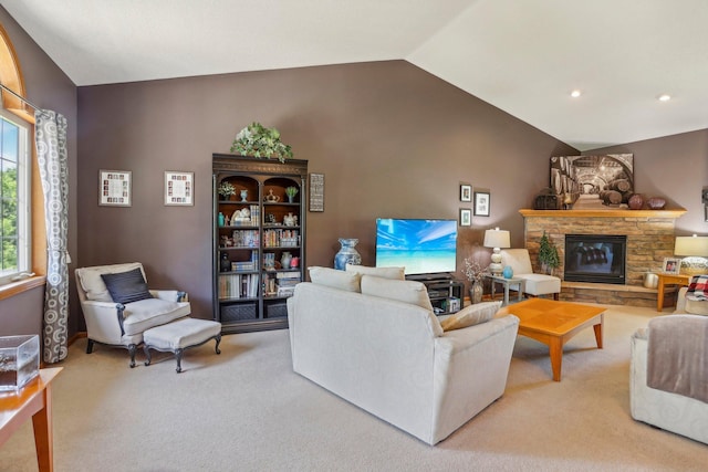 6875 148th Ln NW, Ramsey, MN 55303 - living room featuring vaulted ceiling, light colored carpet, a stone fireplace, and recessed lighting