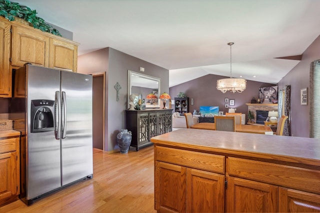 6875 148th Ln NW, Ramsey, MN 55303 - kitchen with stainless steel fridge, a chandelier, light wood-type flooring, open floor plan, and hanging light fixtures