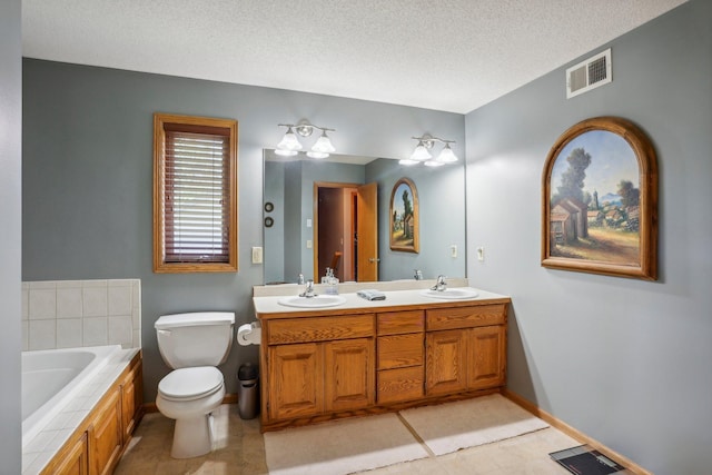 6875 148th Ln NW, Ramsey, MN 55303 - bathroom with double vanity, a garden tub, a textured ceiling, toilet, and baseboards
