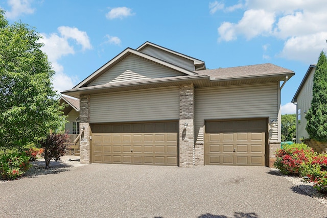 6875 148th Ln NW, Ramsey, MN 55303 - view of front of property with an attached garage, driveway, and roof with shingles