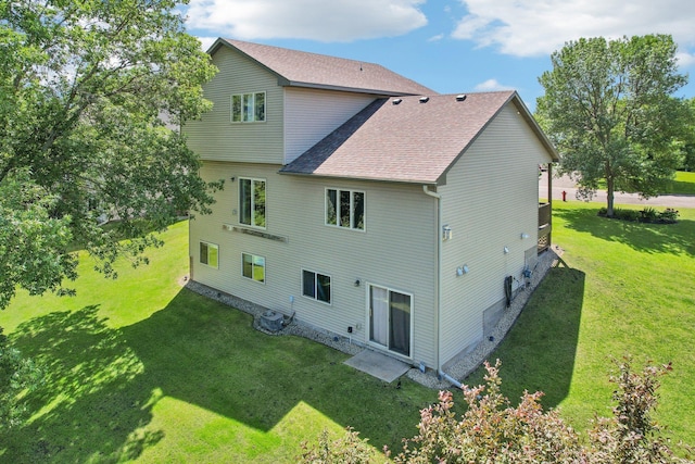 6875 148th Ln NW, Ramsey, MN 55303 - rear view of house with roof with shingles and a lawn