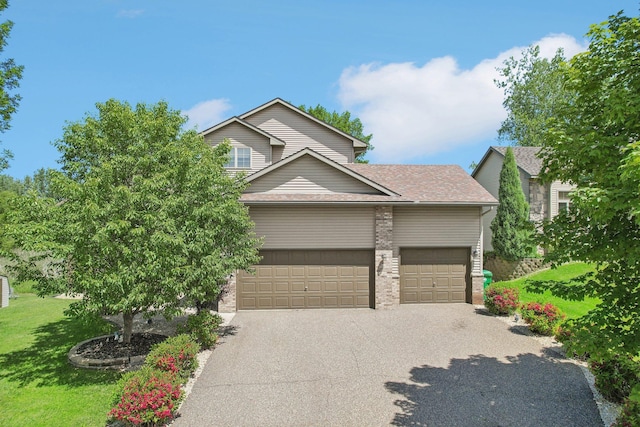 6875 148th Ln NW, Ramsey, MN 55303 - view of front of home with driveway, a front lawn, a garage, and roof with shingles
