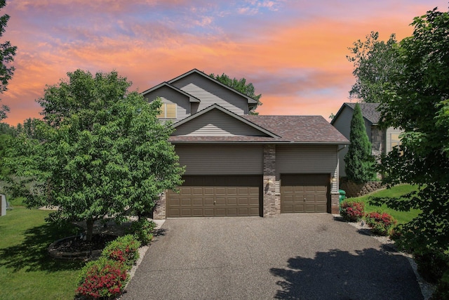 6875 148th Ln NW, Ramsey, MN 55303 - view of front of home featuring driveway, an attached garage, a lawn, and roof with shingles