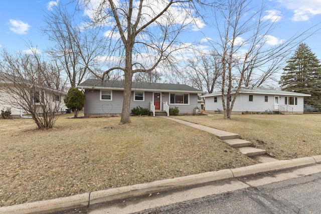 ranch-style home featuring entry steps and a front yard