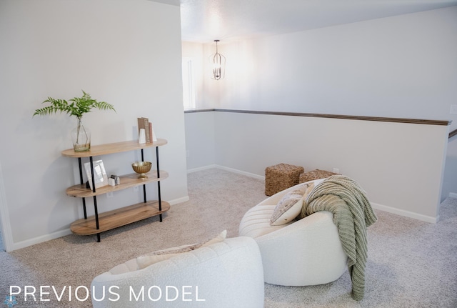 living area with baseboards and carpet flooring
