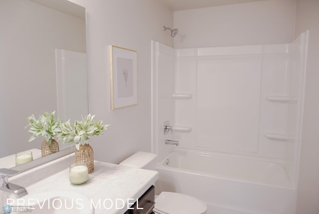 bathroom featuring vanity, toilet, and shower / washtub combination