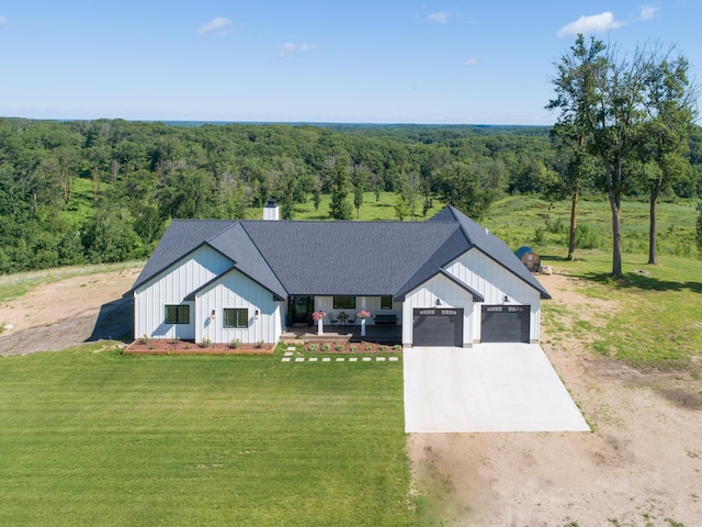 38525 Northstar Dr, Cushing, MN 56443 - modern inspired farmhouse featuring a shingled roof, a front yard, a view of trees, a garage, and driveway