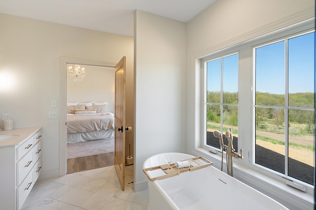 38525 Northstar Dr, Cushing, MN 56443 - ensuite bathroom featuring a soaking tub, an inviting chandelier, ensuite bath, and vanity