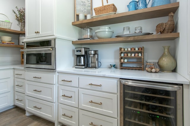 38525 Northstar Dr, Cushing, MN 56443 - kitchen featuring open shelves, wine cooler, white cabinets, and oven