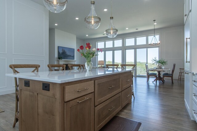 38525 Northstar Dr, Cushing, MN 56443 - kitchen with a breakfast bar, an inviting chandelier, a decorative wall, and wood finished floors