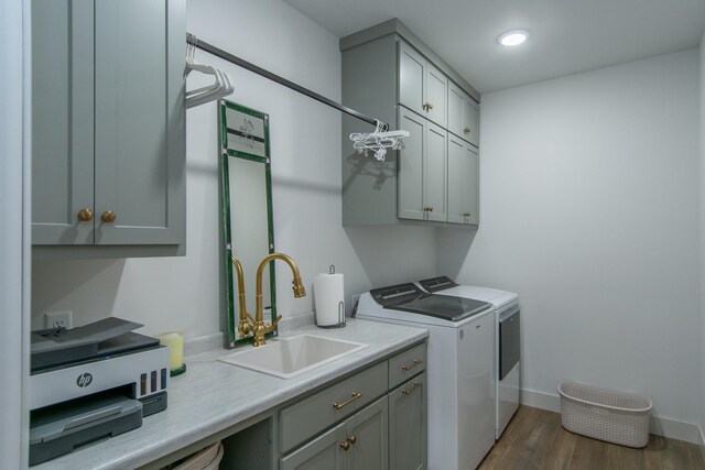 38525 Northstar Dr, Cushing, MN 56443 - washroom featuring wood finished floors, baseboards, cabinet space, a sink, and independent washer and dryer