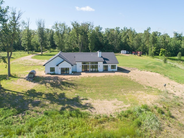 38525 Northstar Dr, Cushing, MN 56443 - view of front of home with a chimney, a front yard, and a patio area