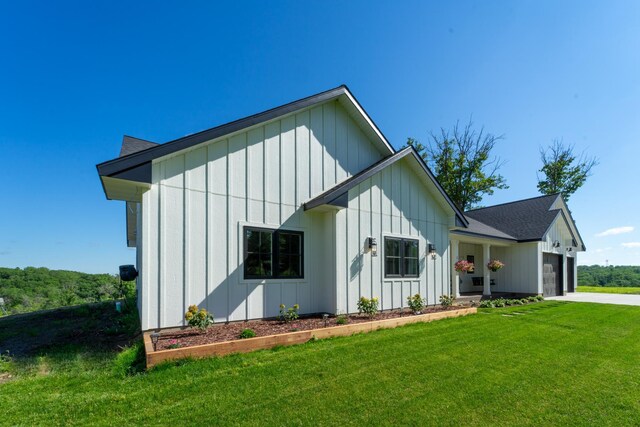 38525 Northstar Dr, Cushing, MN 56443 - view of front of house with board and batten siding, a front lawn, a garage, and concrete driveway
