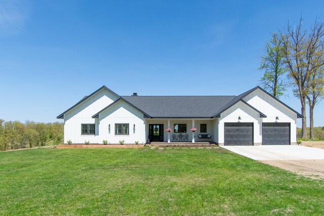 38525 Northstar Dr, Cushing, MN 56443 - modern farmhouse style home featuring a porch, roof with shingles, concrete driveway, an attached garage, and a front yard