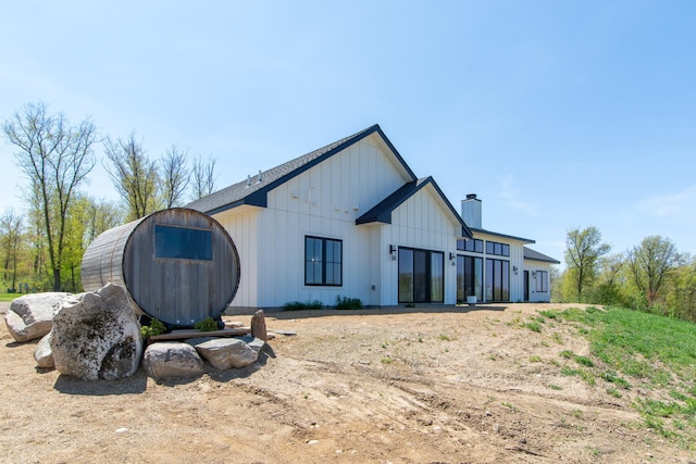 38525 Northstar Dr, Cushing, MN 56443 - back of property featuring board and batten siding and a chimney