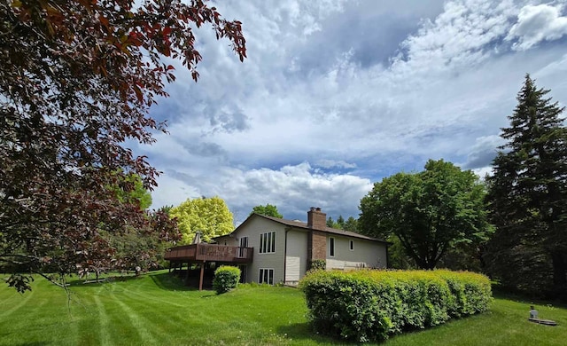 7331 175th Ave NW, Ramsey, MN 55303 - rear view of property featuring a chimney, a deck, and a lawn