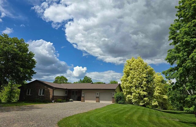 7331 175th Ave NW, Ramsey, MN 55303 - view of front of property featuring a garage, gravel driveway, brick siding, and a front yard