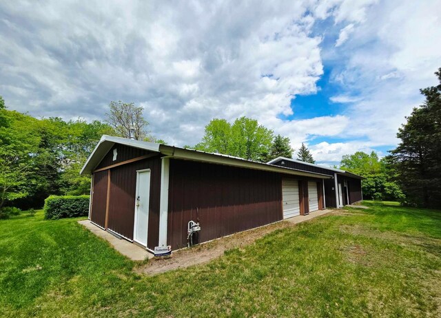 7331 175th Ave NW, Ramsey, MN 55303 - view of side of home featuring an outbuilding, a yard, and a detached garage