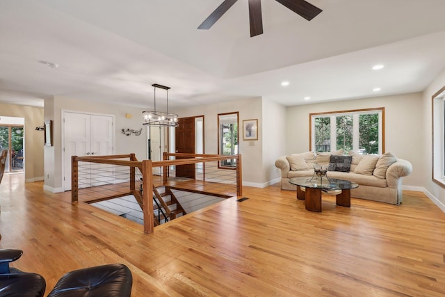 17180 Jordan Ct, Lakeville, MN 55044 - living area with light wood finished floors, recessed lighting, healthy amount of natural light, baseboards, and a ceiling fan