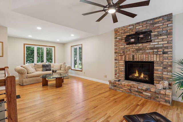 17180 Jordan Ct, Lakeville, MN 55044 - living room with light wood-style flooring, recessed lighting, ceiling fan, baseboards, and a fireplace