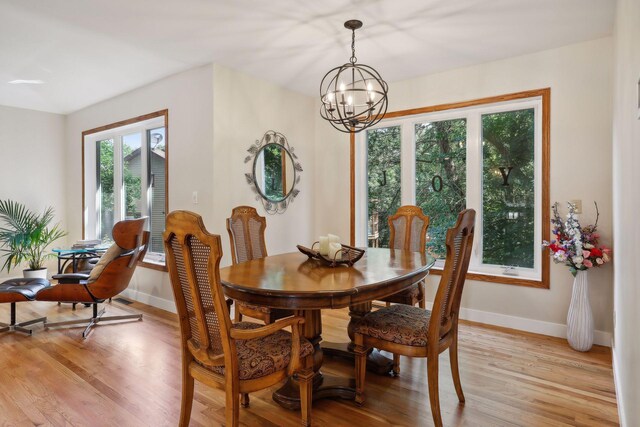 17180 Jordan Ct, Lakeville, MN 55044 - dining area featuring a chandelier, light wood finished floors, and baseboards