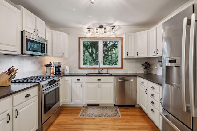 17180 Jordan Ct, Lakeville, MN 55044 - kitchen featuring stainless steel appliances, a sink, dark countertops, and white cabinets