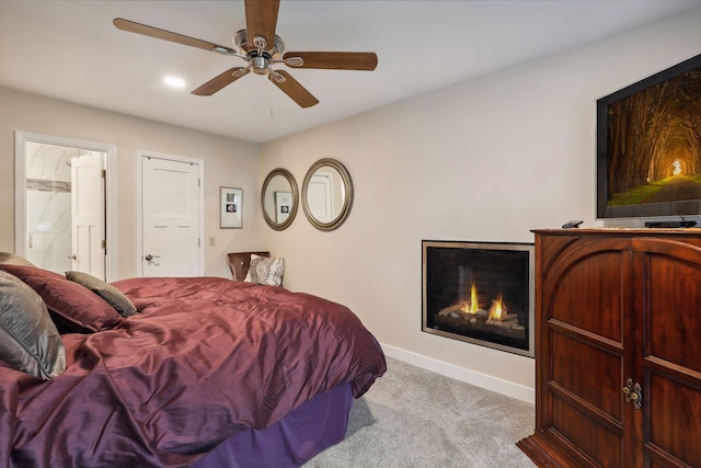 17180 Jordan Ct, Lakeville, MN 55044 - bedroom featuring carpet floors, a lit fireplace, baseboards, and ceiling fan