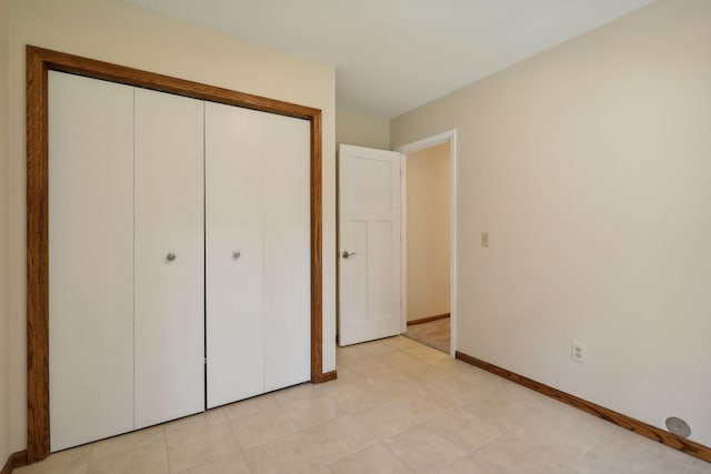 17180 Jordan Ct, Lakeville, MN 55044 - unfurnished bedroom with baseboards, a closet, and light tile patterned floors