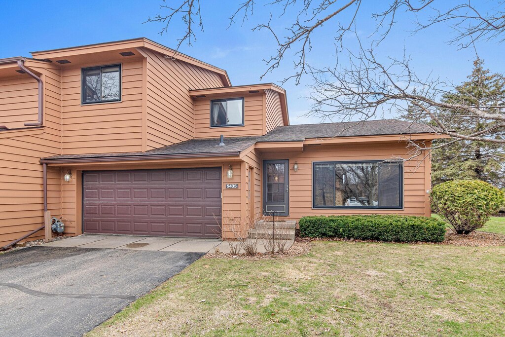 5435 Upper 147th St W, Apple Valley, MN 55124 - view of front of property with an attached garage, aphalt driveway, and a front yard