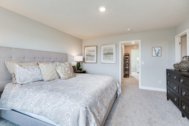 bedroom featuring baseboards, light carpet, and recessed lighting
