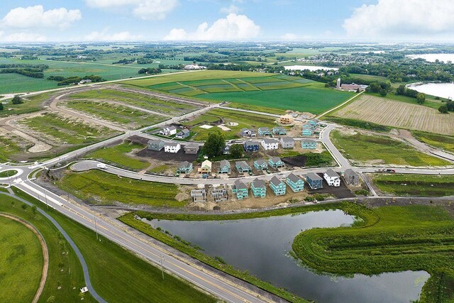 aerial view of property and surrounding area with a large body of water and rural landscape