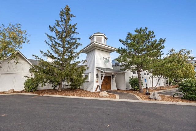 view of front of home with a shingled roof