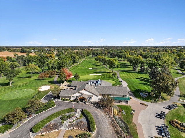 aerial view of property and surrounding area with a golf course