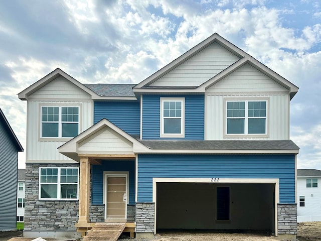 craftsman-style house with stone siding and a garage