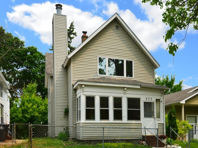 277 Morton St E, Saint Paul, MN 55107 - rear view of house featuring a chimney