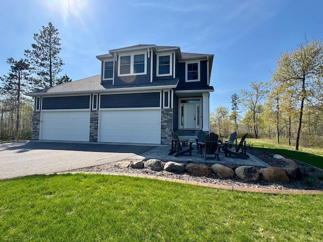 view of front of property featuring stone siding, asphalt driveway, a shingled roof, a front yard, and an attached garage