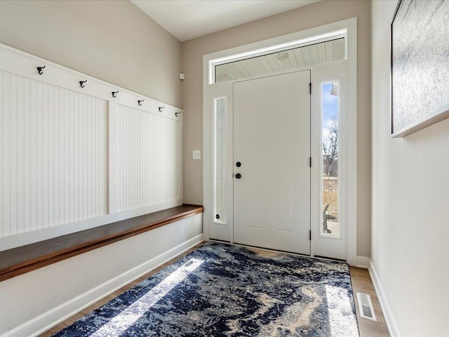 entryway with wood finished floors and baseboards
