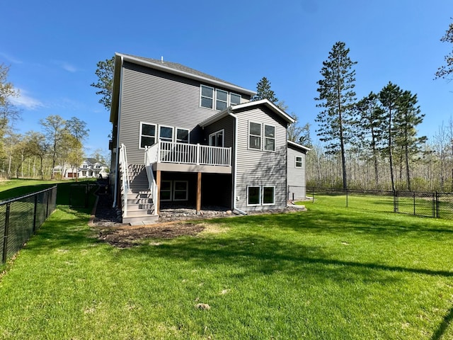 rear view of property with a wooden deck and stairs