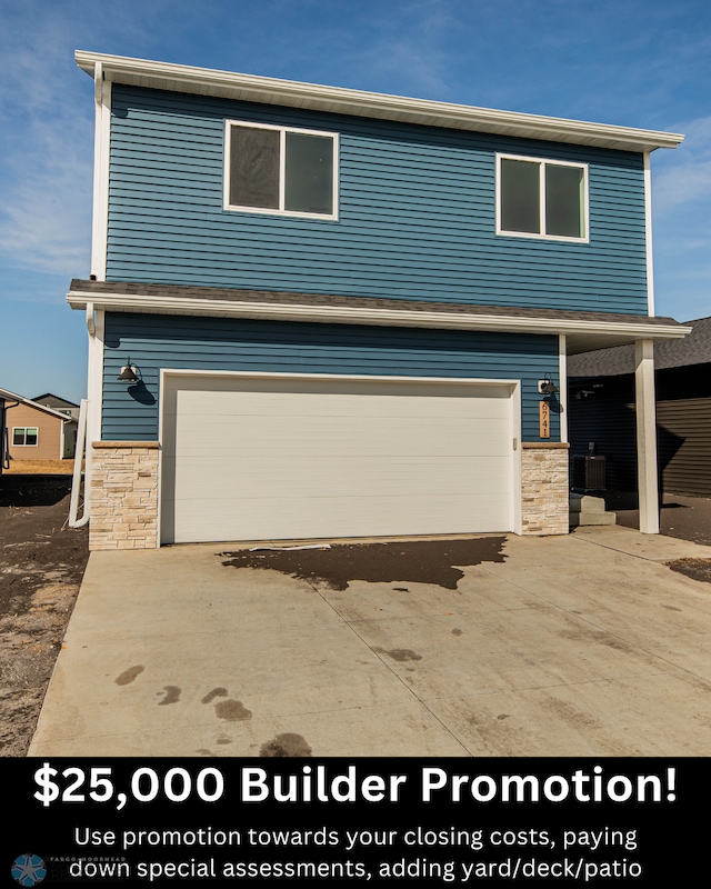 6741 67th Ave S, Horace, ND 58047 - view of front of property featuring stone siding, a garage, and driveway